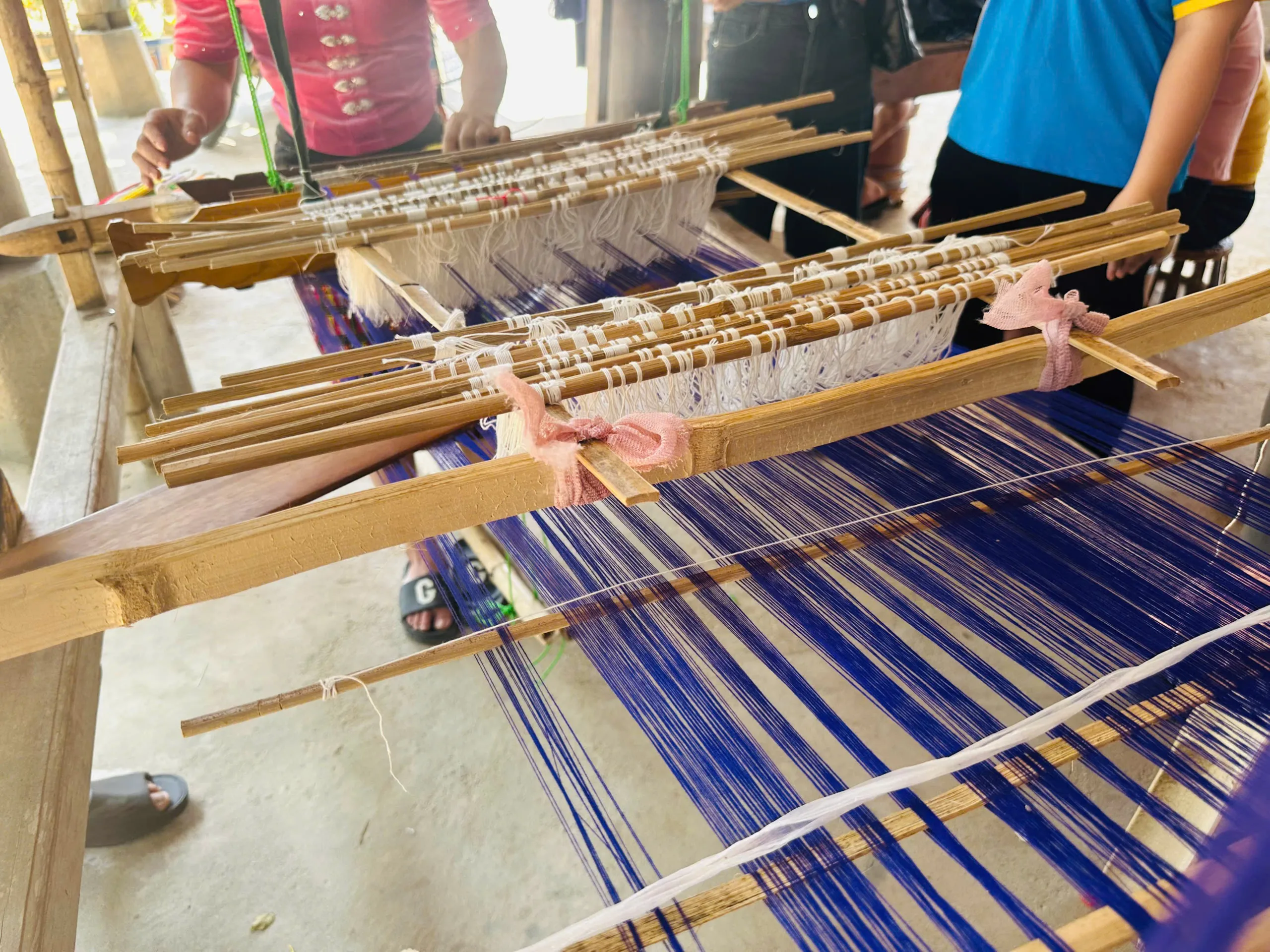 Traditional Thai brocade weaving on a loom in Chau Khe